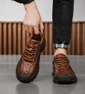 Detail showing brown textured leather upper and thick anti-slip rubber sole of men's shoe