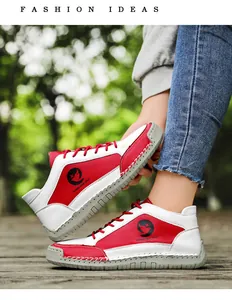 Détail de basket en cuir rouge et blanc montrant la semelle cousue main et le logo rond