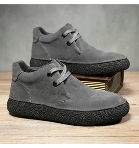 Detailed macro view of dark grey suede leather upper with reinforced stitching and rubber sole