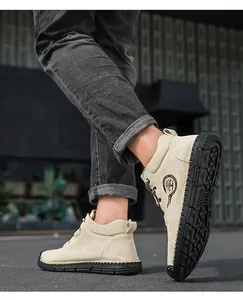Detailed close-up of beige suede high-top men shoes with durable rubber soles