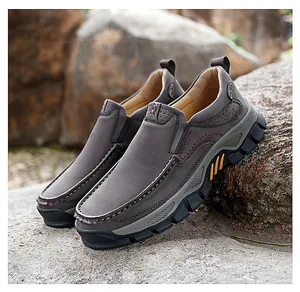 Macro detail of men's leather outdoor shoes with contrast stitching on grey-brown upper