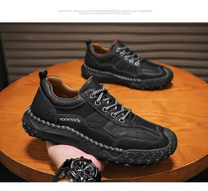Detailed view of black litchi texture leather shoes with sturdy rubber soles and stitching