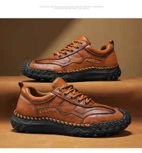 Detail of hand-stitched brown leather men's outdoor shoes with durable rubber traction sole
