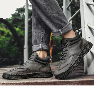Dettaglio stivaletti in pelle PU grigio scuro con cuciture a mano su piattaforma in legno