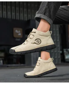 Detail of handmade stitching on men's khaki casual boots with durable rubber sole