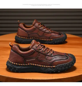 Detailed view of brown leather outdoor loafers with rugged stitching on a wooden surface
