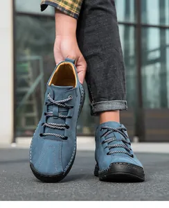 Detail of blue nubuck leather men's shoe with contrast hand stitching and rubber toe cap