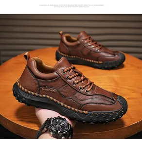 Detail of dark brown leather loafer featuring hand-stitched seams and a lug rubber sole