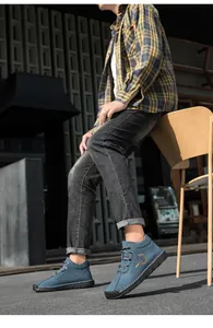 Outdoor low-angle shot of navy blue suede leisure boots with non-slip rubber soles
