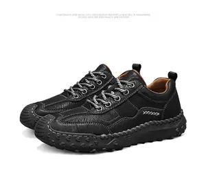 Detailed view of black men's outdoor casual shoes with handcrafted white cross stitching
