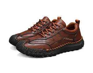 Detail of handmade stitching on brown leather outdoor shoes with durable rubber soles