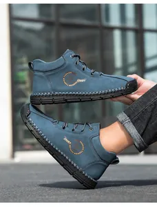 Detail of dark blue nubuck casual shoe featuring white hand-stitched sole and fashion logo