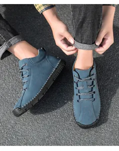 Top-down view of blue suede high-top men's shoes with rugged hand-stitched detailing
