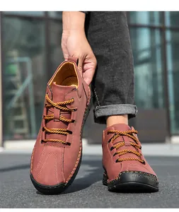 Detail of rust brown suede men's boots featuring 100% rubber toe cap and thick stitching