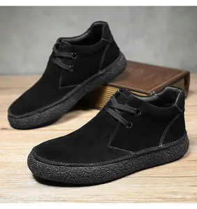 Detail shot of black suede casual shoes with thick textured rubber soles on a wooden table