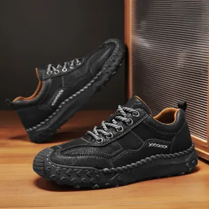 Men's black leather casual loafers with hand-stitched thick rubber soles on wood background