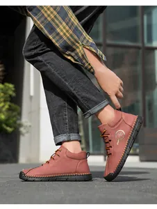 Detail of brown leather outdoor shoe with hand-stitched seams and Fashion Sport logo