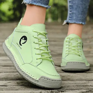 Pale green casual flat ankle boots with handmade stitching and non-slip rubber soles