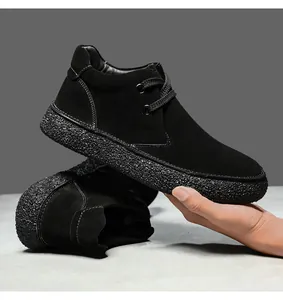 Detail of black suede mid-top shoe showing white contrast stitching and thick rubber sole