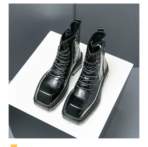 Detailed top view of black crocodile-embossed leather boots with square toe and side zipper