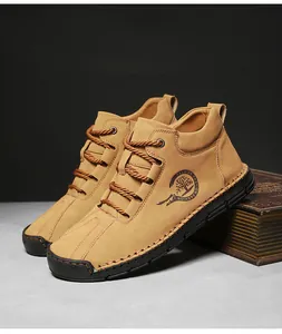 Detail of camel nubuck leather casual boots with fashion logo and vintage book background