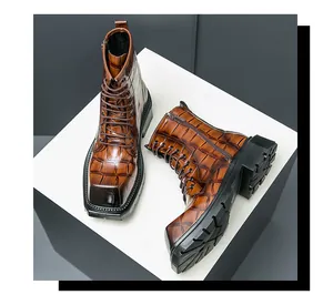 Close-up of brown crocodile embossed leather and side zipper on men's combat boots