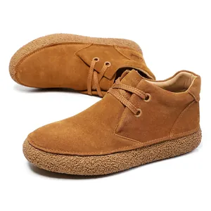Detail of tan suede casual boots with textured thick gum soles and two-eyelet laces