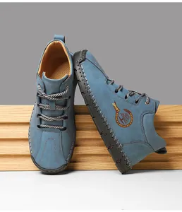 Detail of blue suede outdoor shoes featuring hand-stitched seams and a circular fashion logo