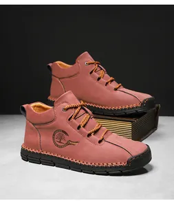 Detail view of men's leather boots featuring bold contrast stitching and outdoor sport logo