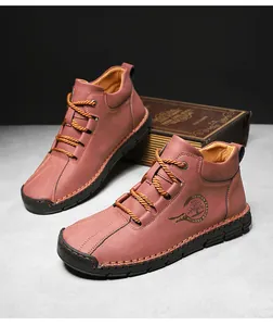 Detail of vintage brown leather mid-top boot with rugged hand-stitching and rope laces