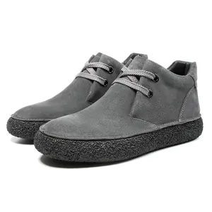 Detailed side view of dark grey suede desert boots with thick non-slip platform soles