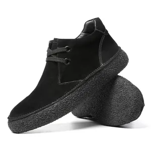 Detail of black suede mid-top casual shoes with thick textured rubber soles for men
