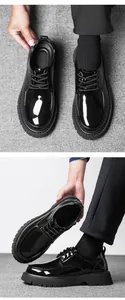 Macro view of men's glossy patent leather loafers with thick non-slip rubber soles