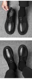 Detail of black platform leather loafers showing polished texture and stitching