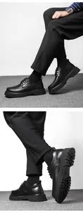 Detailed view of thick lug sole on black leather derby shoes with non-slip texture