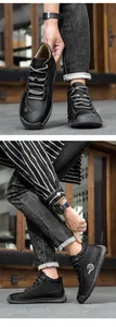 Macro detail of men's black leather shoes with contrast stitching and rubber sole text