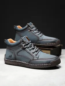 Detail eines blauen Lederstiefels mit Kontrastnähten und 100 % Gummisohle für Herren