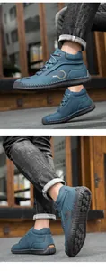 Detail of blue suede high-top boots featuring manual stitching and non-slip rubber soles