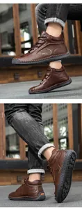 Detail of brown leather men's casual boots showing rugged soles and fashion sport logo