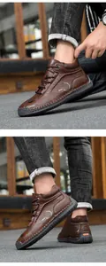 Detail of dark brown leather high-top shoes featuring hand-stitched soles and side print