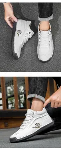 Detail of white leather men's shoe featuring a durable rubber sole and reinforced stitching