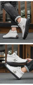 Detailed view of white high-top leather casual shoes with fashion logo and stitched sole