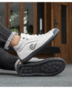 Detail of high-top white leather shoe showing side logo and non-slip black rubber sole