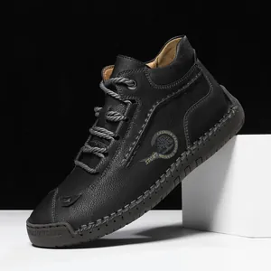 Men's black leather high-top boots with hand-stitched detailing and rubber sole