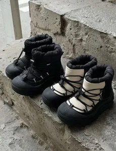 Close-up of thick non-slip rubber soles and waterproof nylon material of winter snow boots