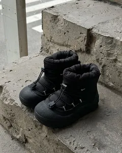 Macro detail of waterproof nylon upper and adjustable drawstring on black snow boots