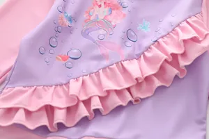 Vue détaillée du maillot de bain sirène pour filles avec volants et texture de tissu pastel