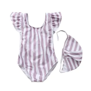 Detail of baby girl swimsuit set featuring purple stripes, ruffles and a matching hat