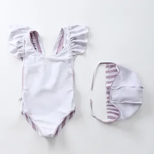 Detail of baby girl's striped ruffle swimsuit set with matching swimming cap