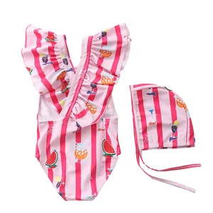 Detail view of girls striped swimsuit with ruffles, watermelon print and matching swim cap